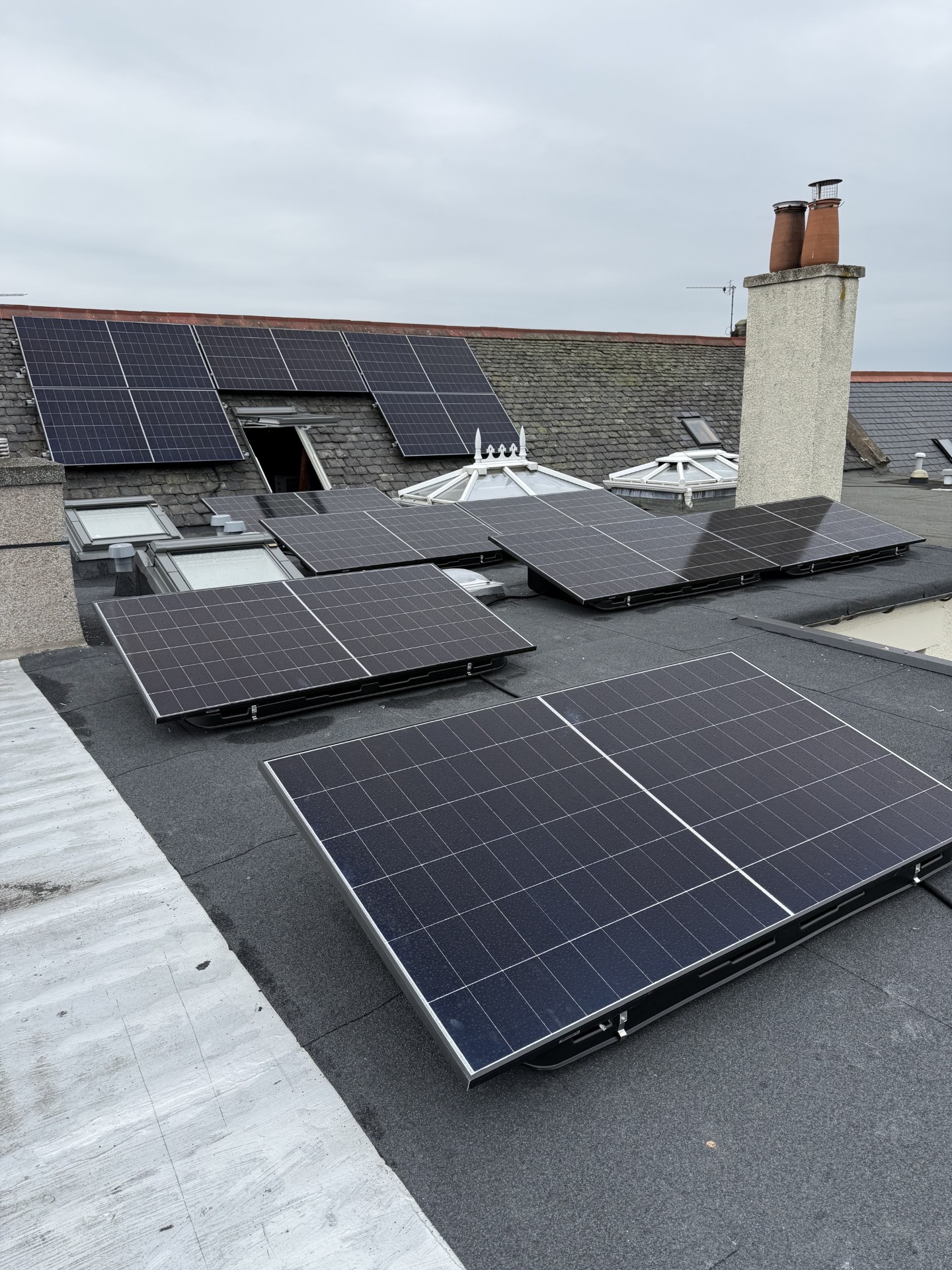 Panels being installed on a Scottish home roof by the Eastern Electric team